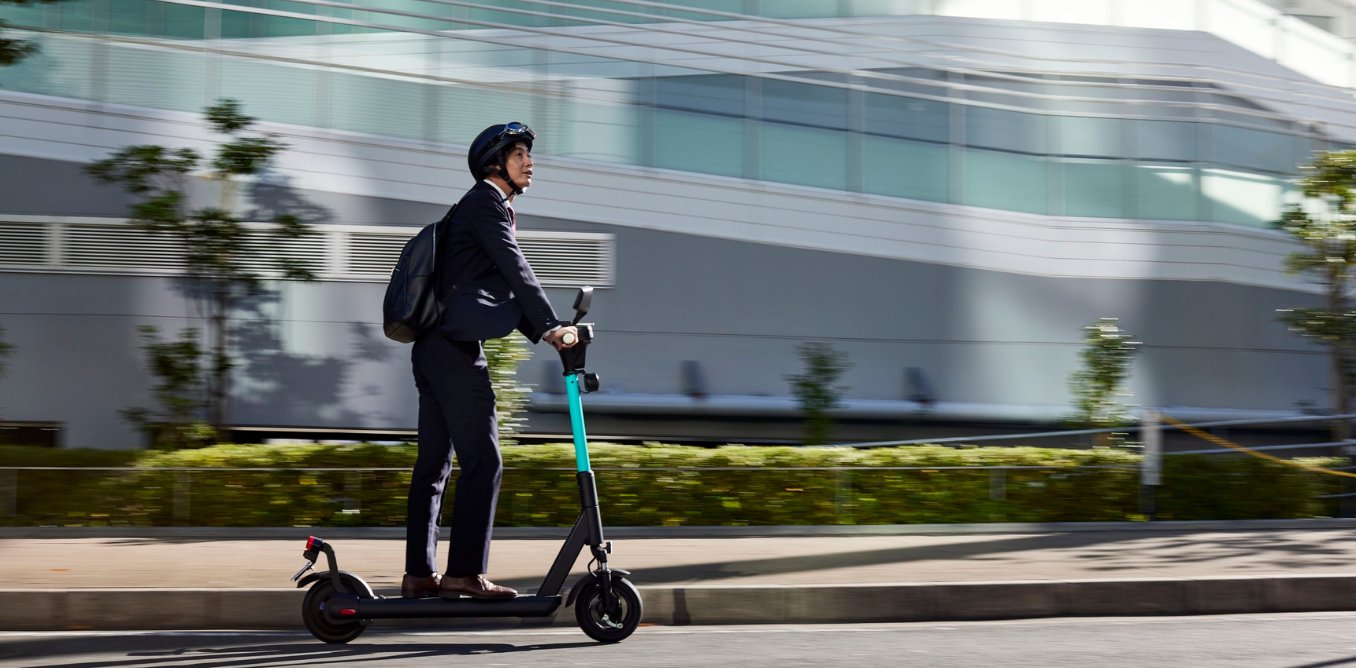 Rider using an approved rental e-scooter in an official trial area