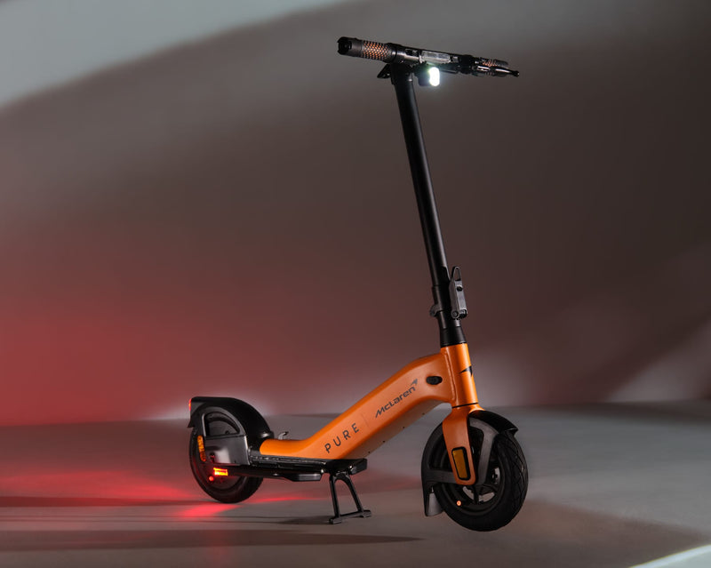 Pure x McLaren Papaya electric scooter in orange, front three-quarter view